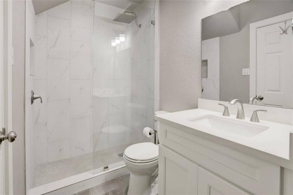 ANOTHER SECONDARY BATHROOM OFFERING A RELAXING WALK-IN SHOWER.