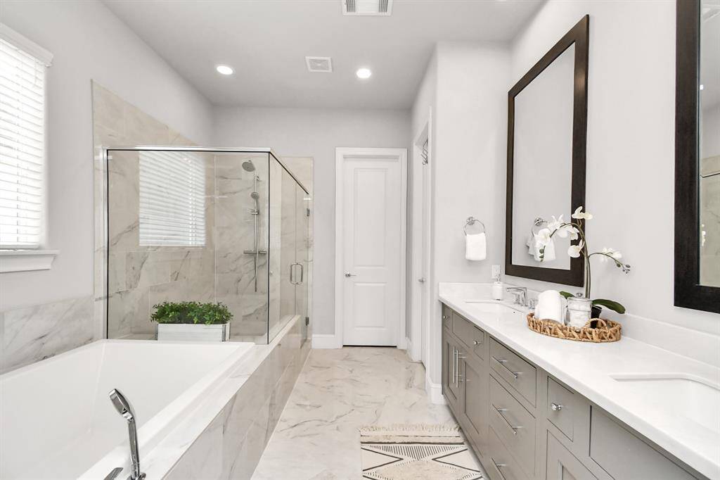 Luxurious bathroom with double sinks with marble countertops.