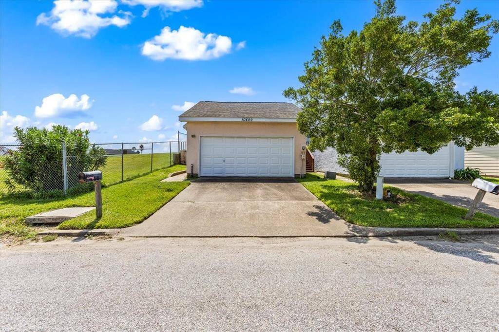 This is a single-story townhome with an attached garage and a driveway for additional parking.
