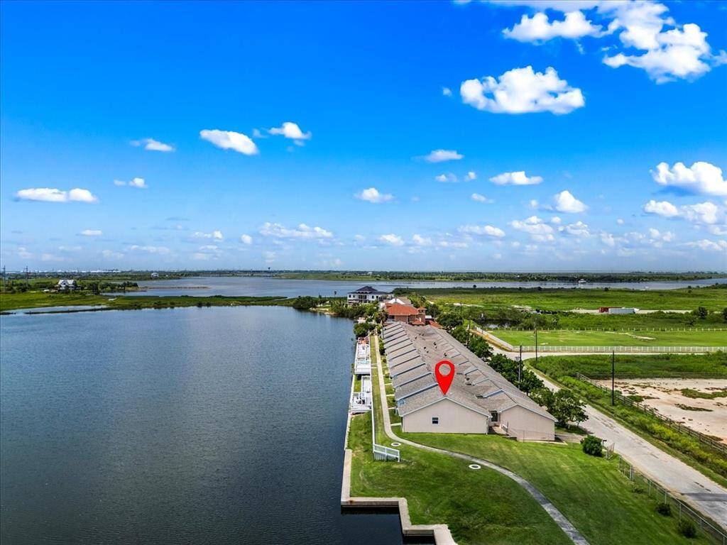 The property is part of a row of townhouses along a well-maintained street, with open green spaces nearby, perfect for those seeking a peaceful lifestyle close to nature.