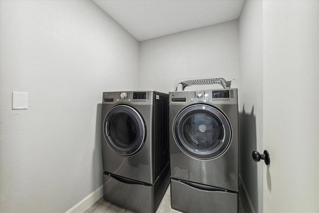 The utility room is located just off the breakfast area. The front loader washer and dryer set with the pedestals stay!