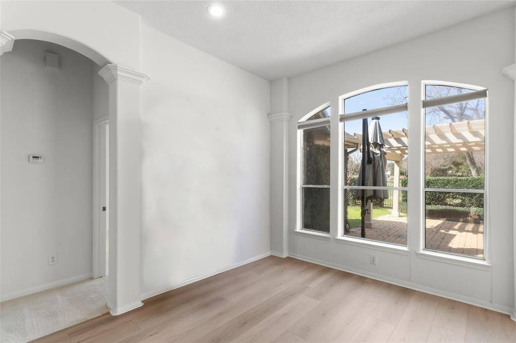 Sunroom between Family Room and Kitchen overlooking back yard on golf course.