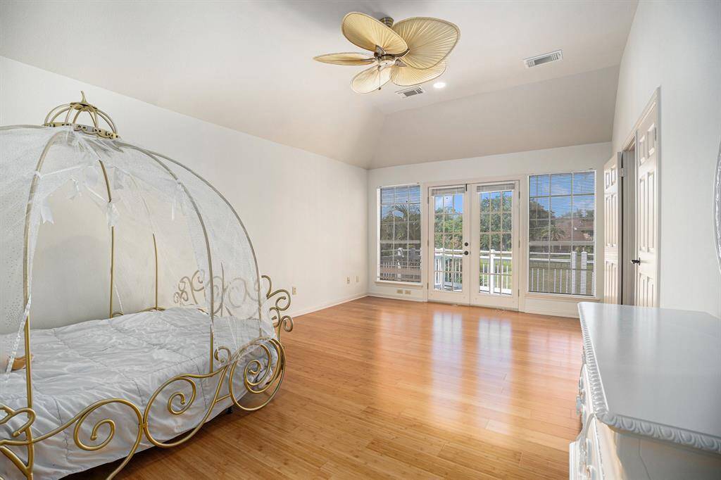 Primary bedroom with a gorgeous balcony overlooking the pool and golf course