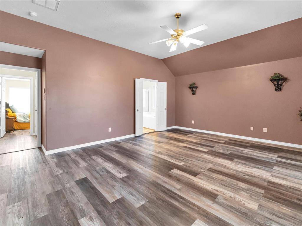 Spacious master suite with high ceilings and plenty of space for a sitting area, complete with an attached ensuite for ultimate privacy and comfort.