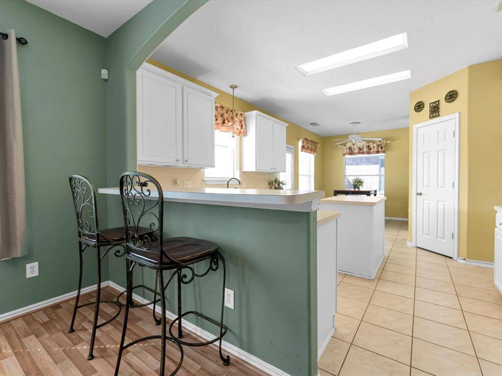 Experience seamless living with a high-top breakfast bar that gracefully connects the kitchen and family room, perfect for entertaining or casual dining.
