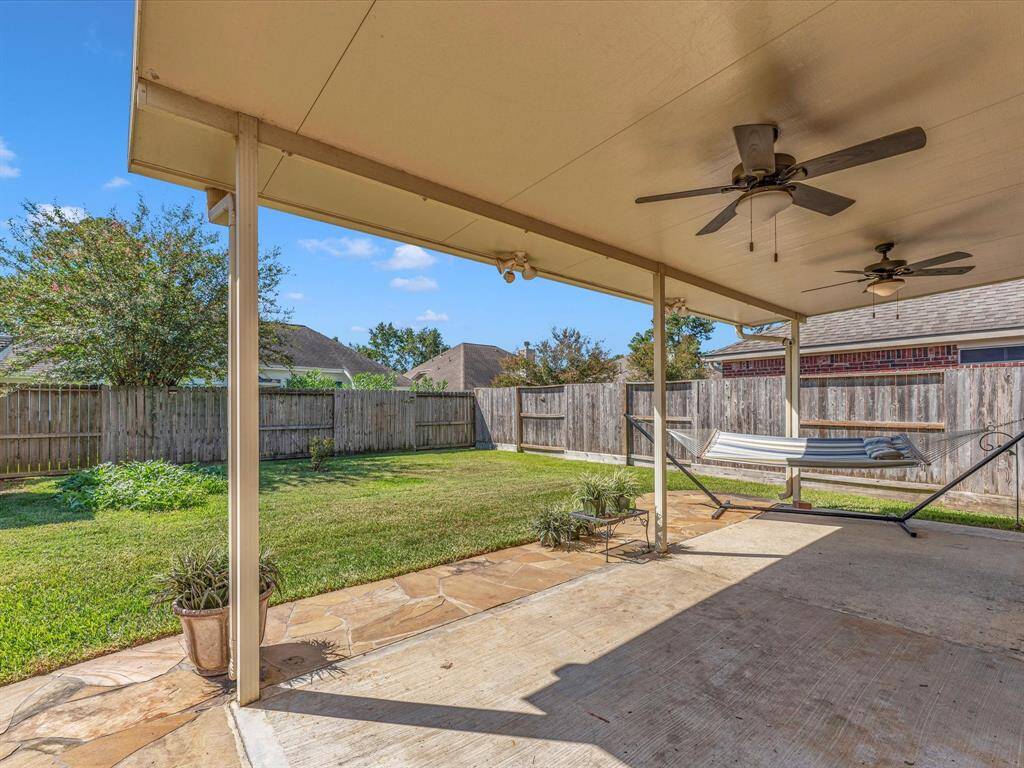 Relax, BBQ and play on the covered back porch that extends almost all the way across the back of the home.