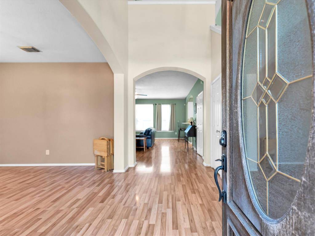 As you walk in the foyer opens up to a spacious dining room on your left and on your right, tucked behind the front door, is the stairs leading up to the bedrooms and game room.
