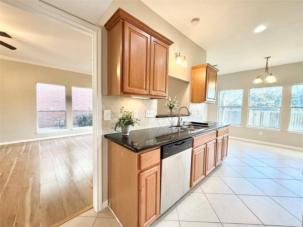 Kitchen with granite counter tops and under cabinet lighting