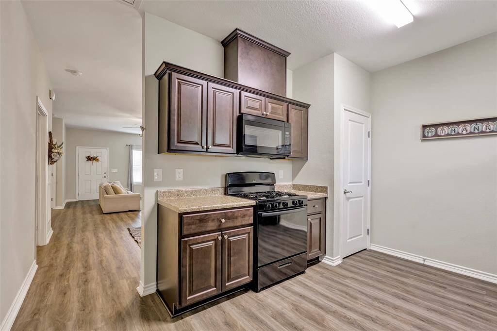 This provides an additional view of the kitchen, with a glimpse of the living area in the background, highlighting the open and connected layout of the home.