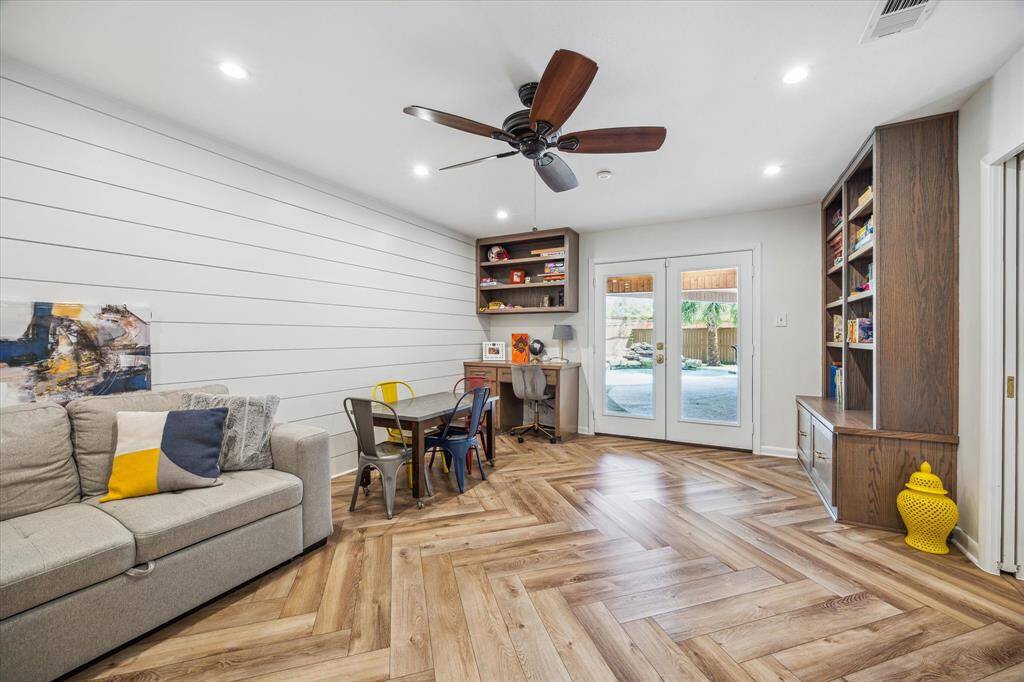 Game room with built-ins opens to covered patio and pool. Could be 5th bedroom, nice sized closet, half bath
