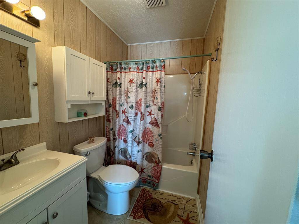Primary private bathroom featuring a combined shower and bathtub.