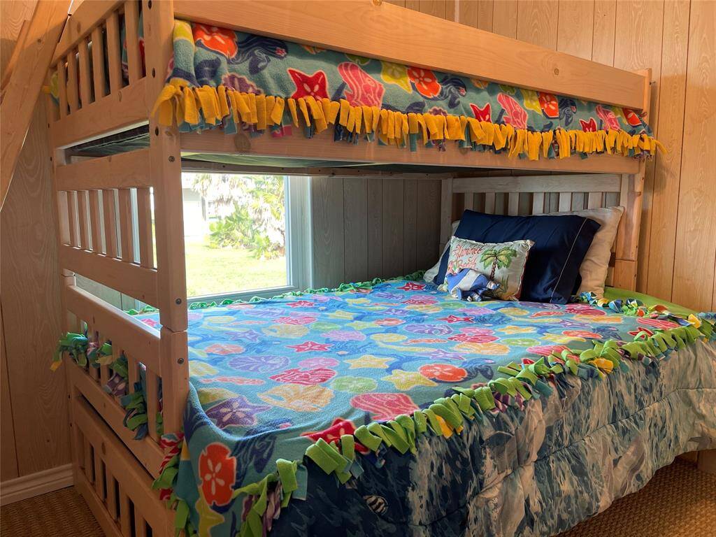 Welcome to this inviting coastal retreat featuring a spacious driveway, an integrated garage, and a charming upper-level balcony promising serene outdoor living.