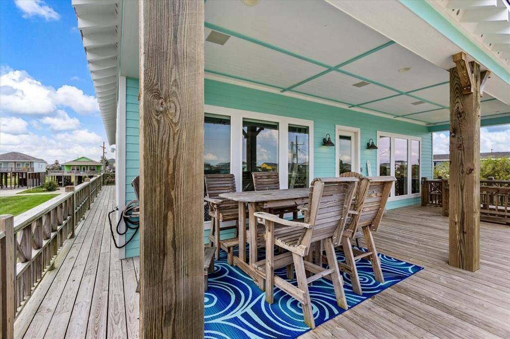Spacious front porch with wraparound deck and room for patio furniture.
