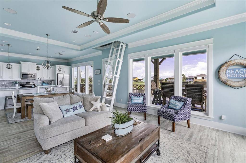 Open concept family room with beautiful natural lighting from windows.