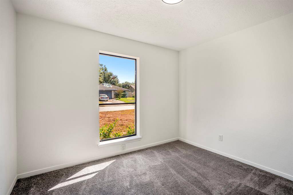 In this alternate view of the second room, a large window brings in an abundance of natural light, creating a bright and comfortable space that feels open and serene.