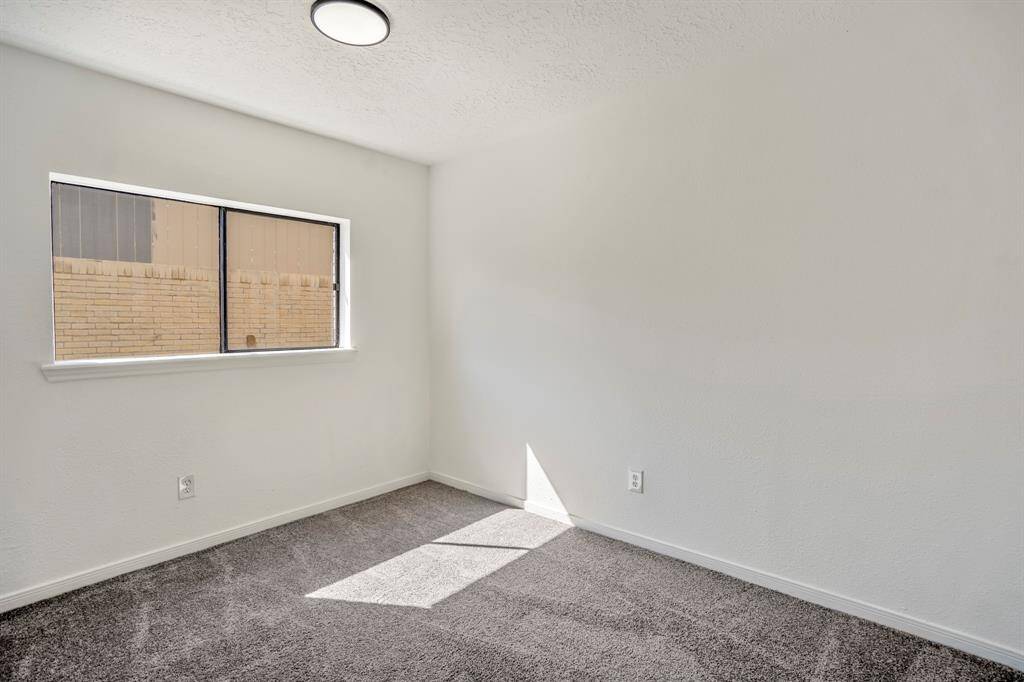 In this alternate view, a large window fills the room with natural light, enhancing the cozy atmosphere and making the space feel bright and inviting.