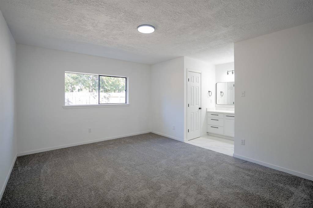 The primary bedroom features brand new, soft carpet that adds warmth and comfort to the space. It also includes a large walk-in closet, offering abundant storage and convenience. This combination of modern updates and ample space creates an inviting, peaceful retreat.
