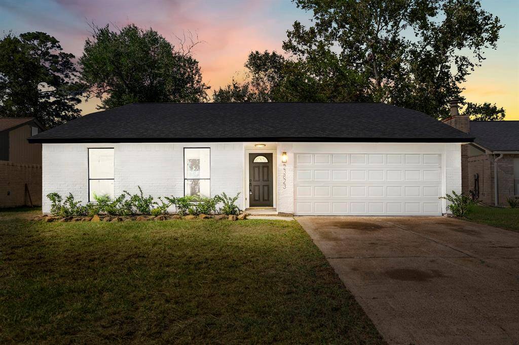Stunning ranch-style home showcasing an immaculate bright white brick exterior, complemented by a beautifully landscaped front yard that enhances its timeless curb appeal