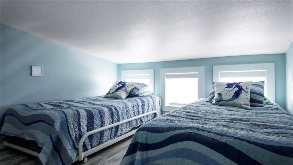 Loft area with two twin beds and TV. This space is directly above family room/kitchen area.