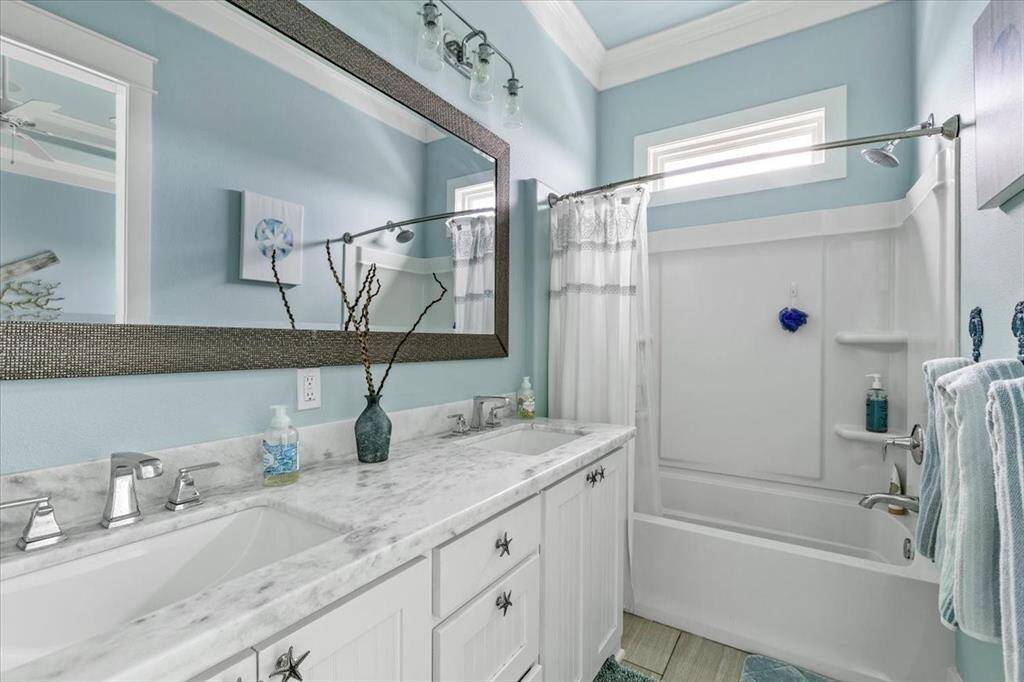 Primary bath with double sinks. Not pictured: enclosed toilet area.
