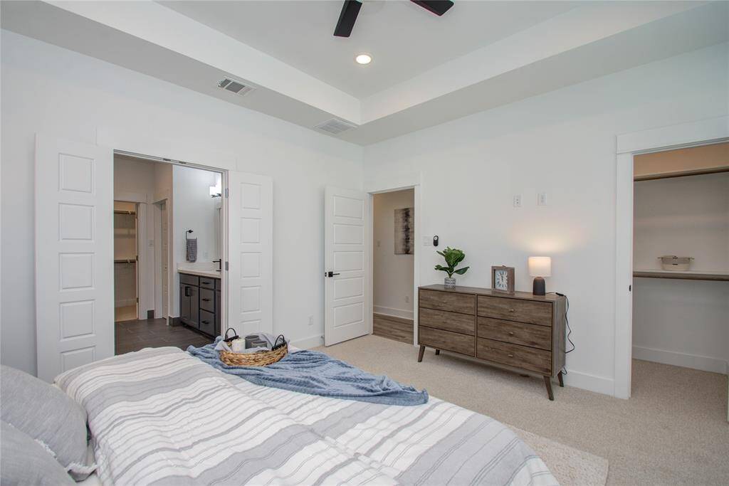 This primary bedroom features 2 closets. Model home photos - FINISHES AND LAYOUT MAY VARY! Ceiling fans are NOT INCLUDED!