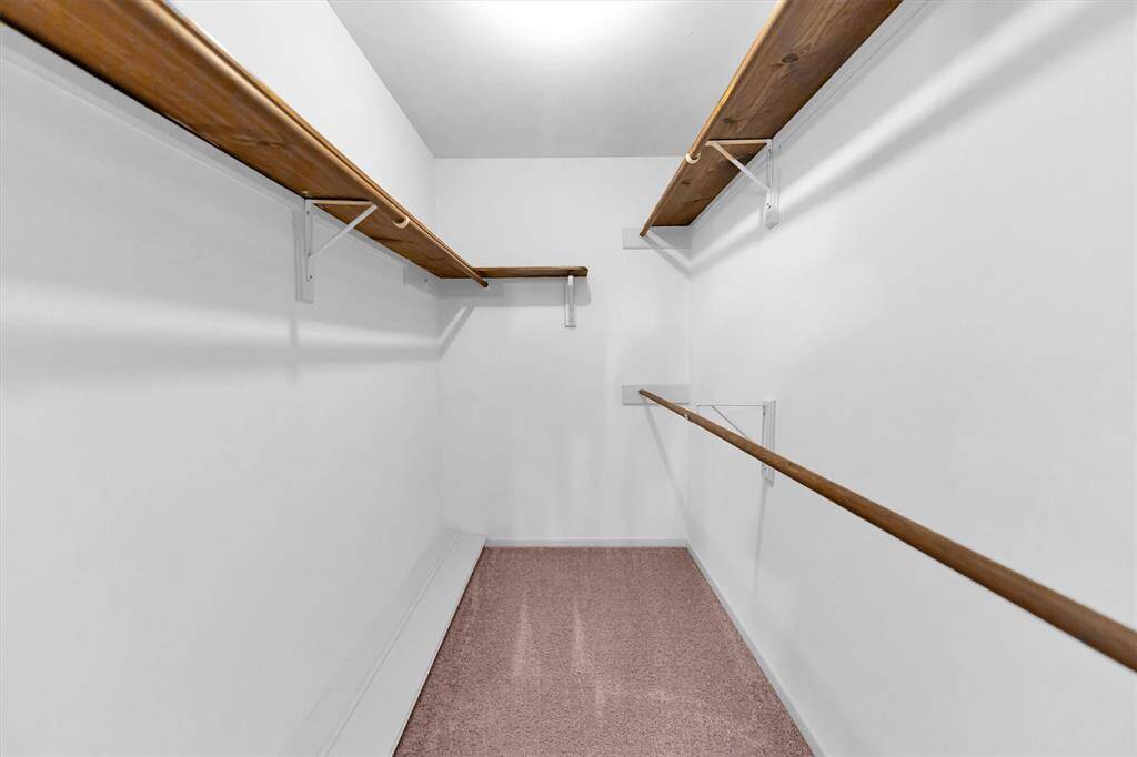 Primary bedroom walk in closet