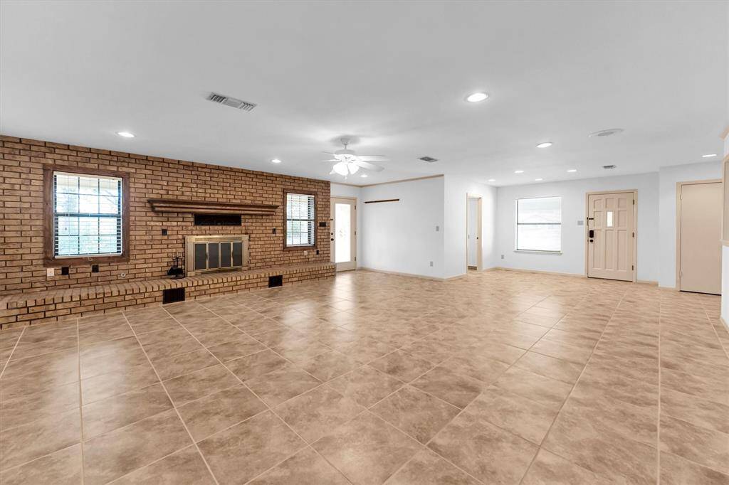 The living room is an expansive, open-concept space that seamlessly blends with the surrounding areas.
