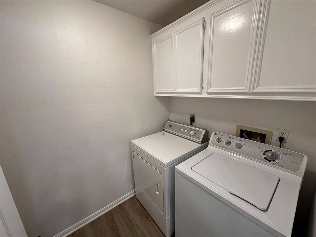Utility room with built-in cabinets and space for a freezer/refrigerator.