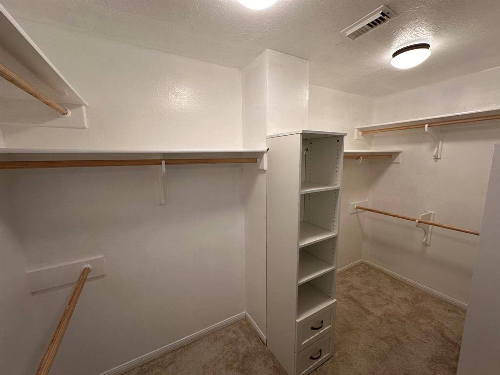 Primary closet with built-in shelving.
