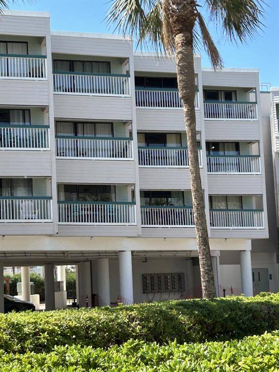 Third floor unit overlooks large central green space with a view of the Gulf of Mexico. Unit is the third one from the right. Covered parking on ground level.