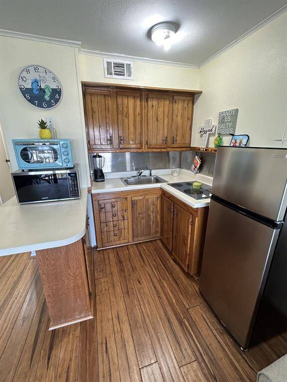 Kitchen area has breakfast bar to the left.