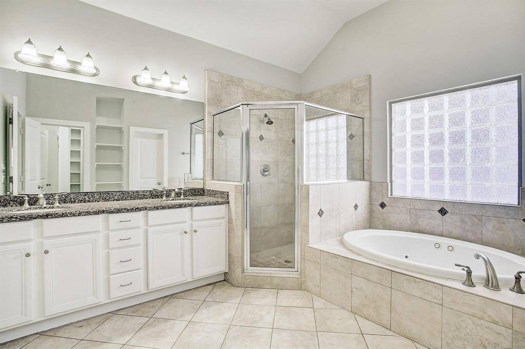luxurious bath with oversized shower, jetted tub and double sinks with granite vanity top.  Lots of storage!!