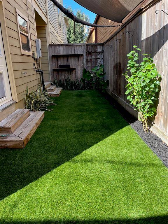 Seller installed artificial turf in back yard for low maintenance.