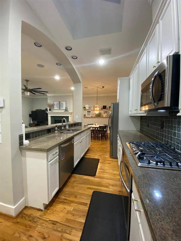 Kitchen has abundant resurfaced cabinets, new backsplash stainless steel appliances, granite countertops and is open to living area and dining area