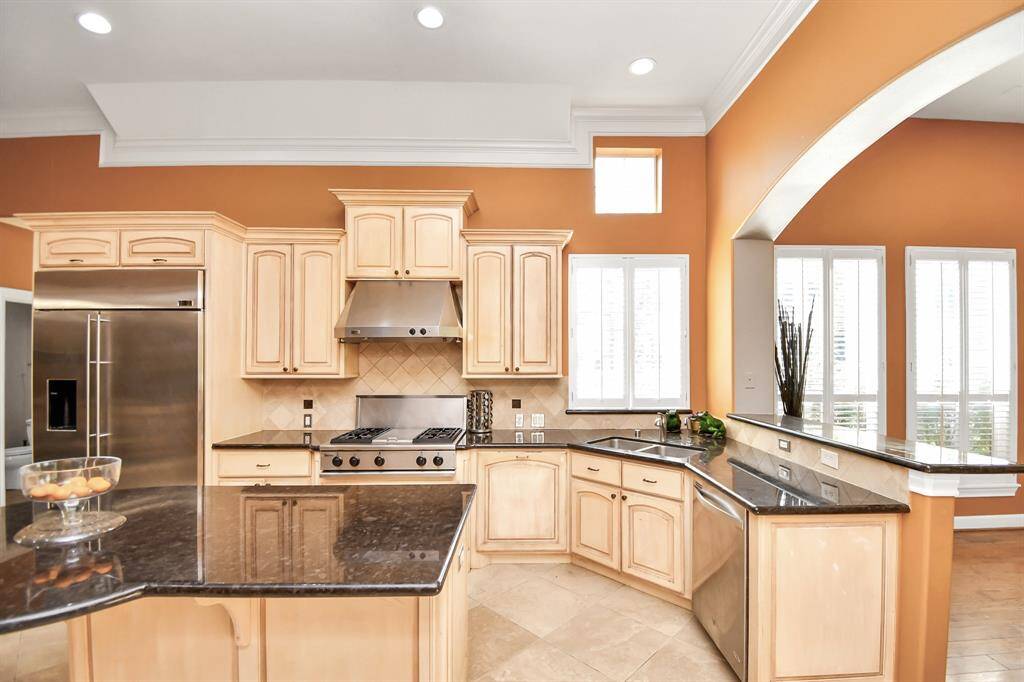 This chef's dream kitchen showcases custom cabinetry and generous storage.