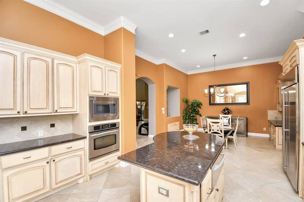 Adjacent to the kitchen, the breakfast area includes a luxurious computer nook for added convenience.