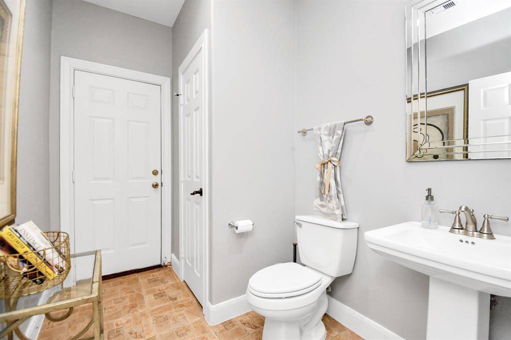 The half bath directly across from the pantry offers direct outdoor access and already plumbed for easy conversion into a pool bathroom, ideal for future poolside gatherings.