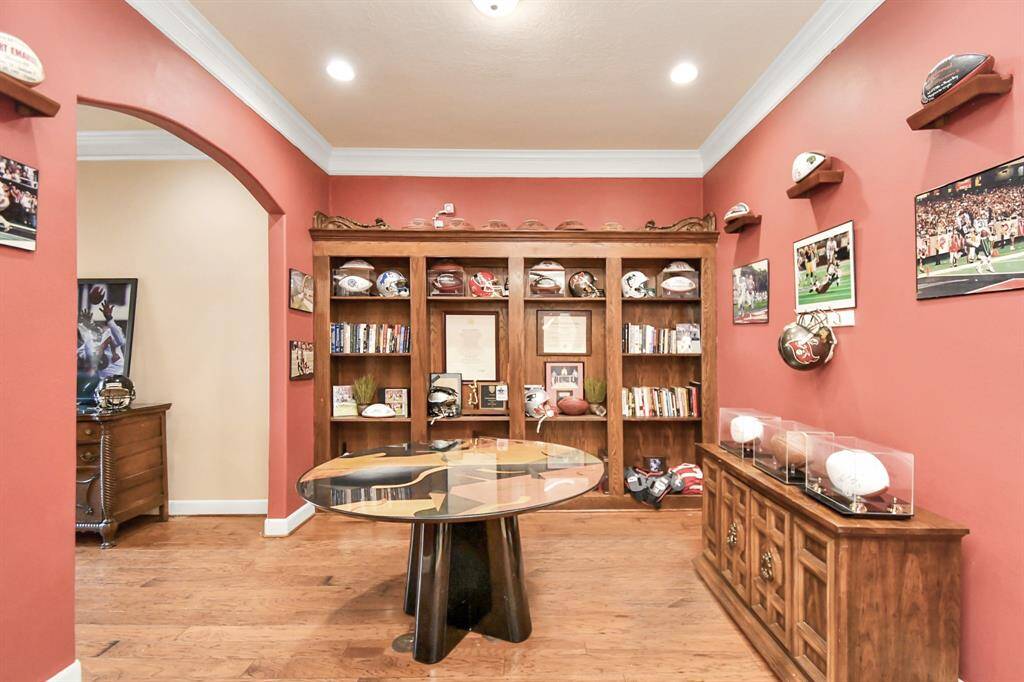 Office space with French doors and built-ins connected to a cozy sitting space or mud room. With pre-installed water connections, this area is primed for creating a breathtaking aquarium, turning it into your personal underwater office retreat.