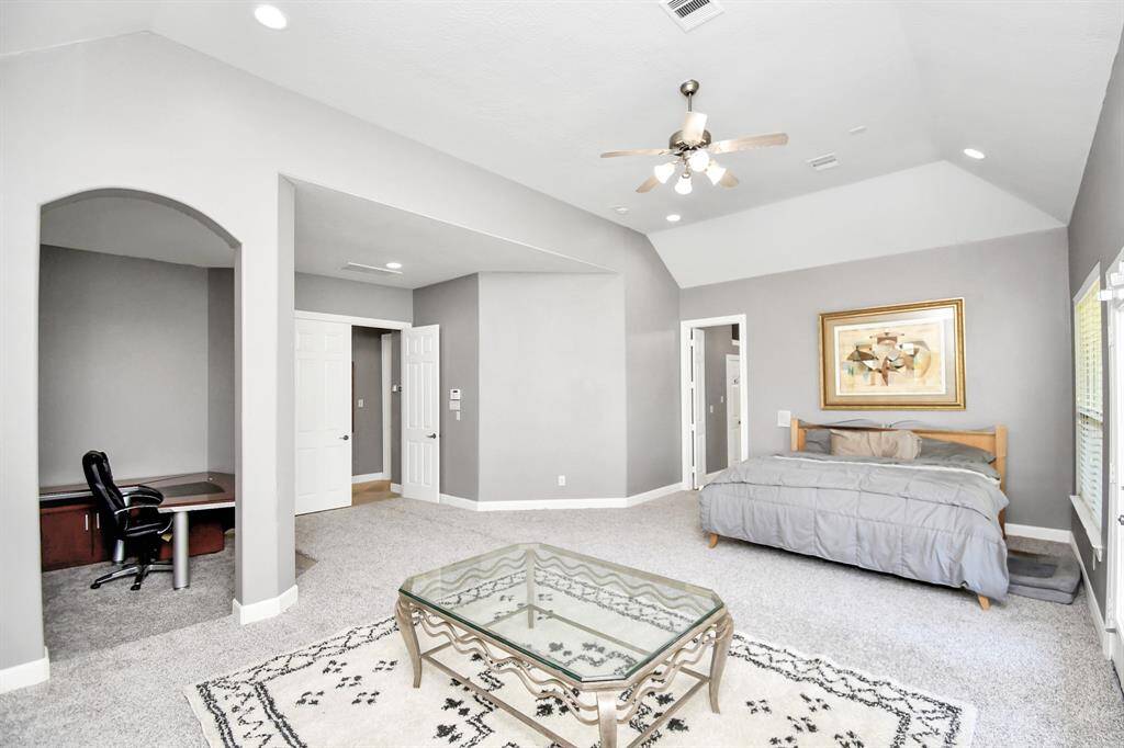 The expansive primary bedroom is situated in a private wing of its own, offering a true retreat within the home. This luxurious suite includes a spacious sitting area that can easily serve as a cozy reading nook, home office, or extra space to tailor to your lifestyle. Thoughtfully designed with convenience in mind, it also provides direct access to a private laundry room and garage adding an extra layer of comfort and functionality. This secluded oasis is the ultimate blend of luxury & privacy.