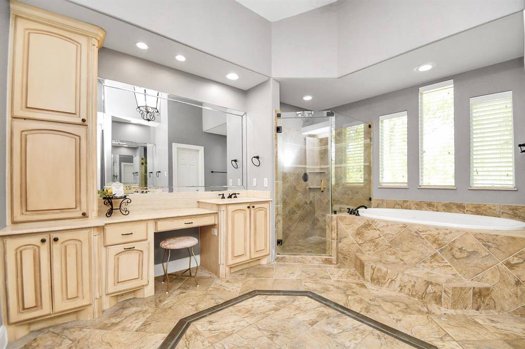 Luxurious master bathroom with spa features and huge closet.