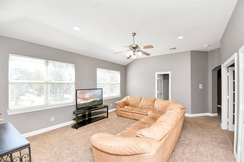 The game room has French doors that lead to a balcony that over looks the family room.