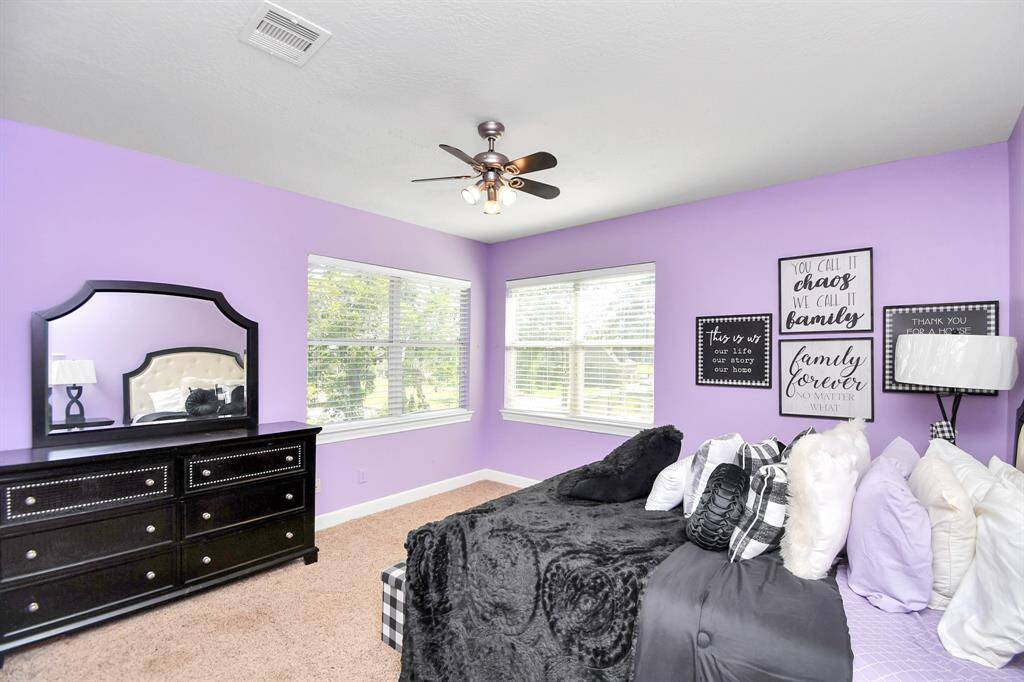 Large secondary bedroom which has access to a huge unairconditioned space that can be converted into a flex space, play room or used in its current condition as an oversized storage space.