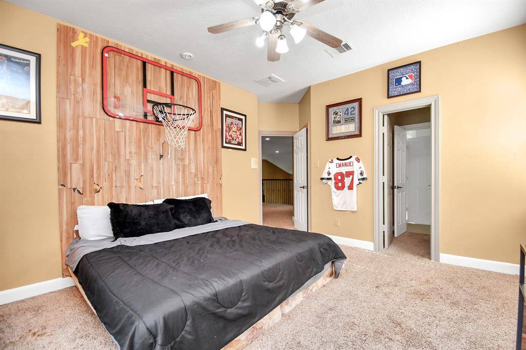 Large secondary bedroom has a vanity area that connects to a bathroom, plus an extra vanity accessible from the game room.
