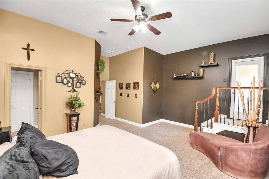 Large secondary bedroom that features a private balcony the overlooks the front of the property and has a Jack and Jill bathroom.