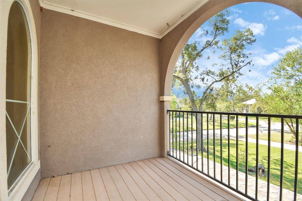 Step out onto the private balcony off this secondary bedroom and be captivated by the panoramic views of the estate. This elevated outdoor space offers a serene escape, perfect for enjoying morning coffee or soaking in sunsets.