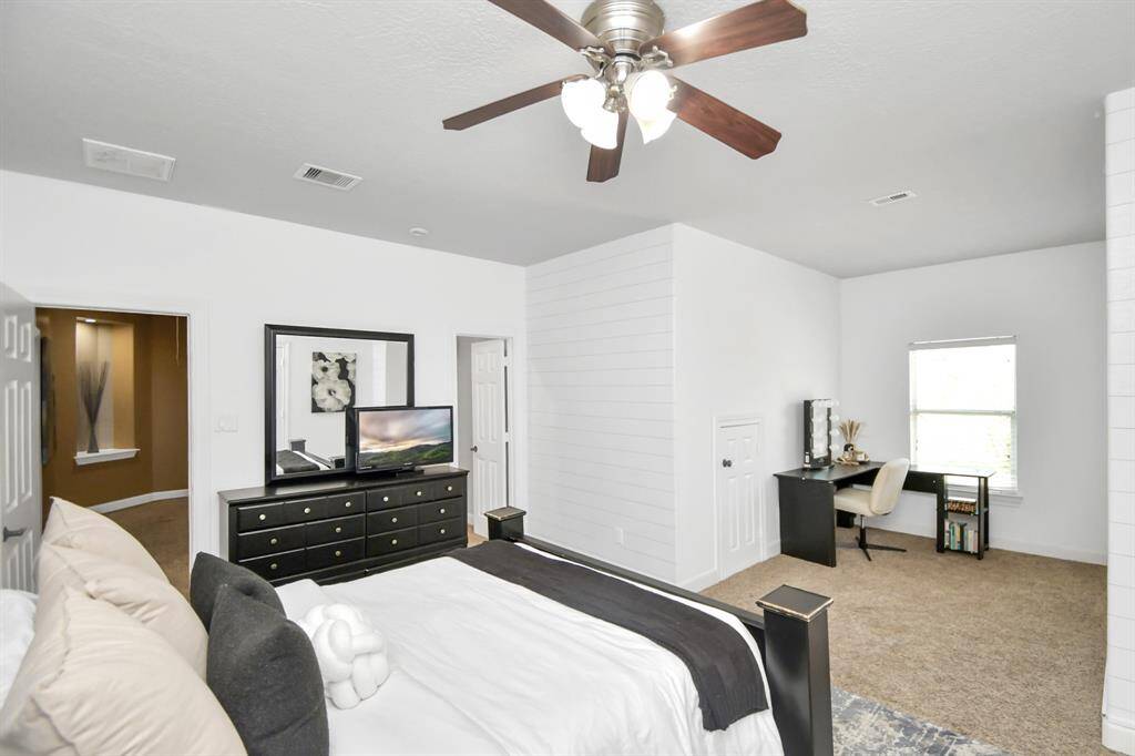 The generously sized secondary bedroom offers a perfect blend of comfort and style, complete with a private sitting area ideal for relaxation or a quiet escape. This versatile space provides endless possibilities, from creating a cozy reading nook to a chic lounge area. Adding to its appeal, the bedroom is connected to a well-appointed Jack and Jill bathroom shared with the third bedroom, offering both privacy and convenience.