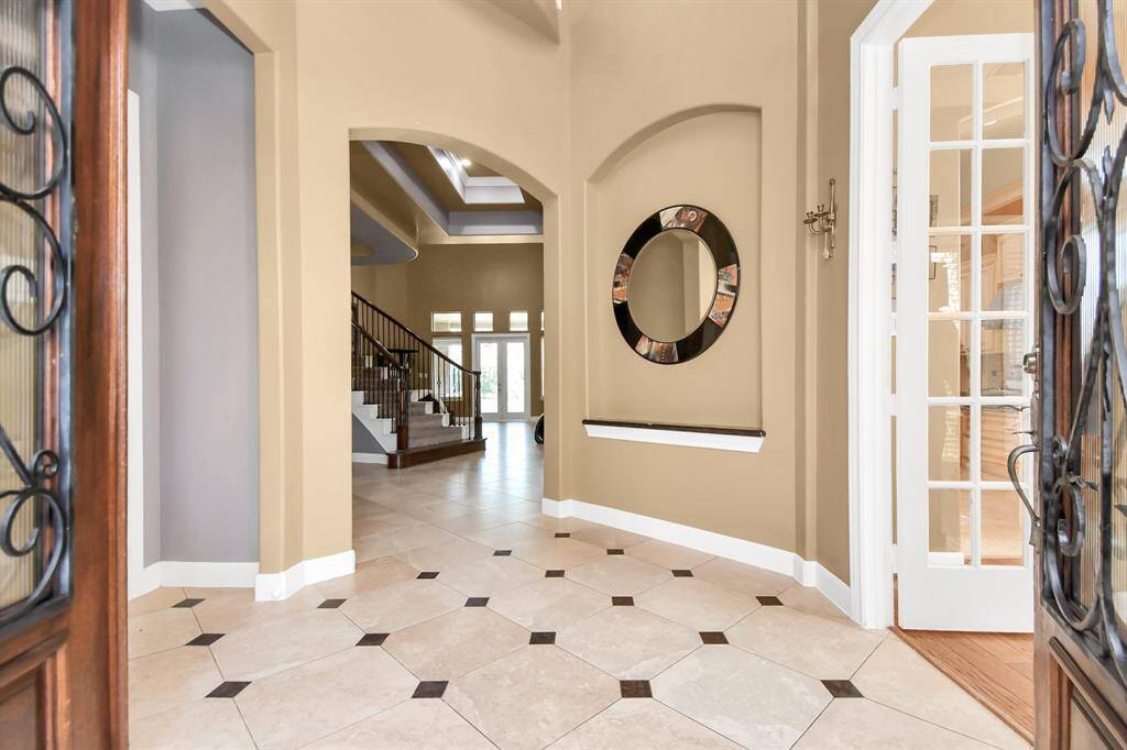 Welcome home! As you step into this magnificent luxury home, you're immediately greeted by a breathtaking foyer with soaring high ceilings that create a grand sense of space and elegance. Above, the stylishly designed computer room overlooks the foyer.