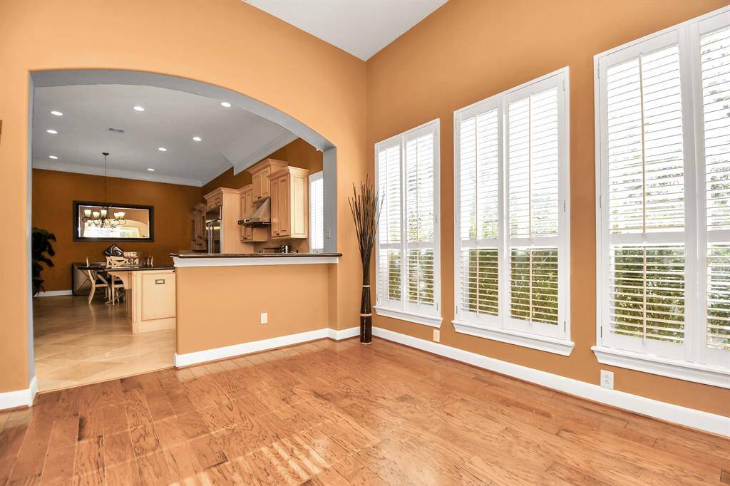 The bright and airy sunroom is a true haven of relaxation, bathed in natural light and designed to be the perfect retreat for unwinding with a good book, savoring your morning coffee, or simply soaking in the peaceful ambiance. Its charming shutters add a touch of classic elegance while offering privacy and adjustable light. With direct access to the front porch sitting area, this seamless indoor-outdoor connection enhances the appeal, creating a tranquil space ideal for both quiet moments casual gathers!