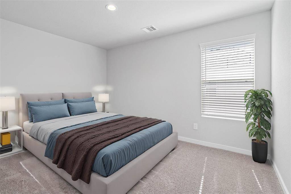 This secondary bedroom features custom paint, plush carpet, and a large window with privacy blinds!