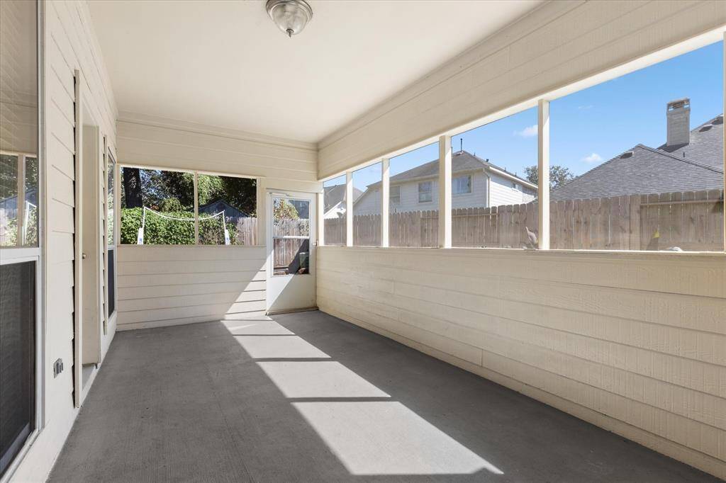 Fabulous screened covered patio. This is a bright and airy enclosed area with large windows providing plenty of natural light and views of the backyard. The space features a neutral color palette and is versatile for relaxation or entertaining.